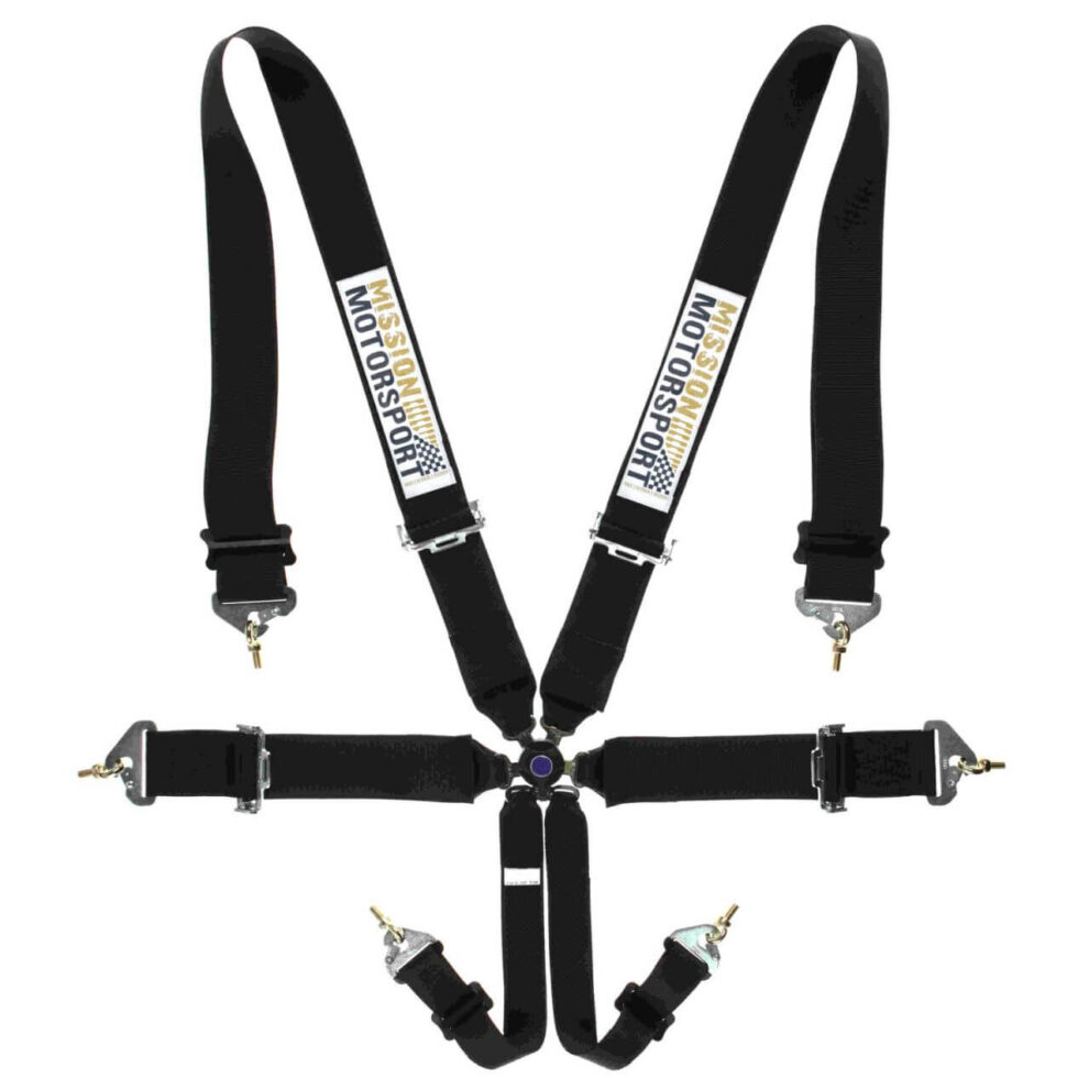A black Mission Motorsport 6 point harness belt laid out flat with its gold and black logo pads on the shoulder straps