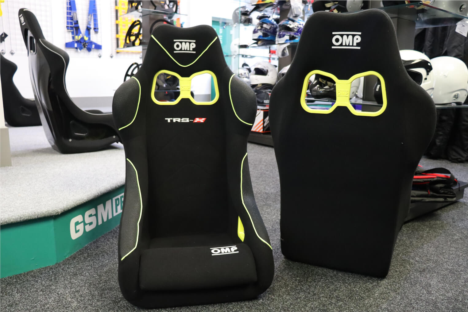 Two OMP TRS-X bucket seats side by side in our showroom, one seen from the back and one from the front