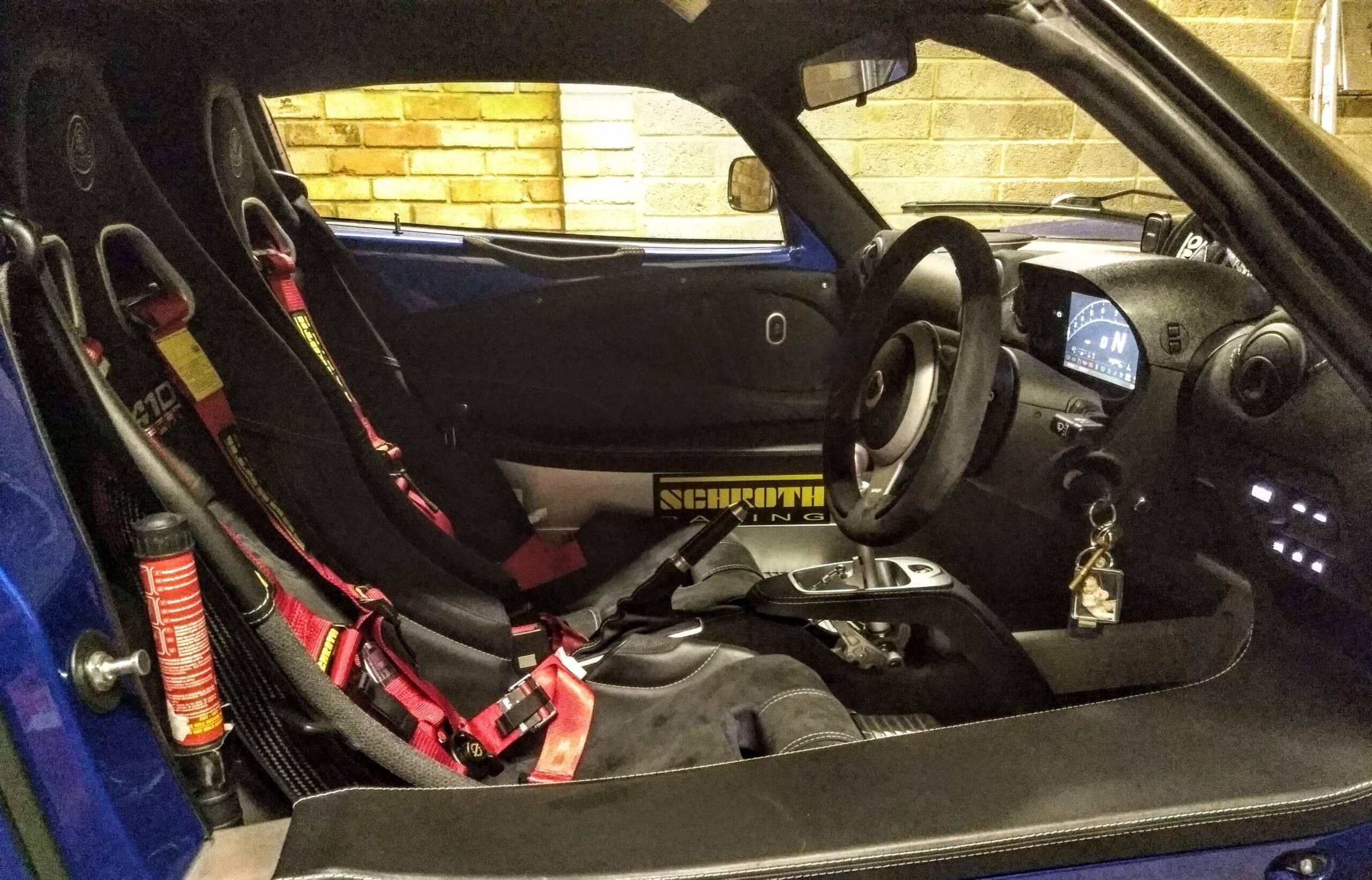 Red Schroth harnesses fitted in a customer's Lotus Exige, with twist release buckles. These are motorsport belts