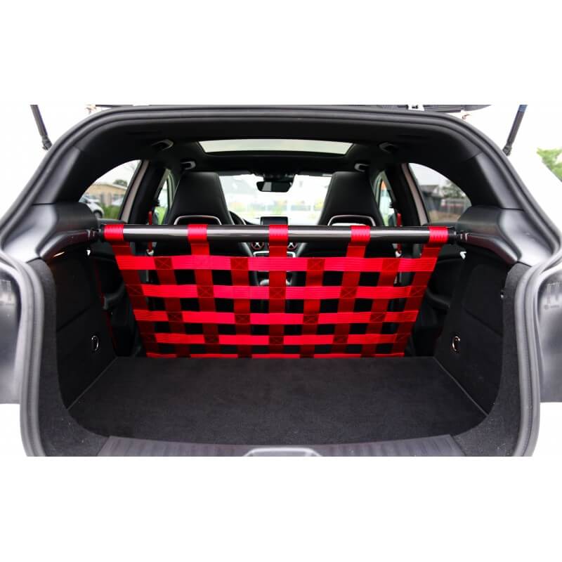 The open boot of a white Mercedes A-Class with a black strut bar and a red webbing net, two bucket seats visible beyond