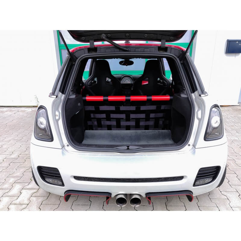 The open hatch of a silver R56 Mini with a red and black strut bar and a black webbing net, two bucket seats beyond
