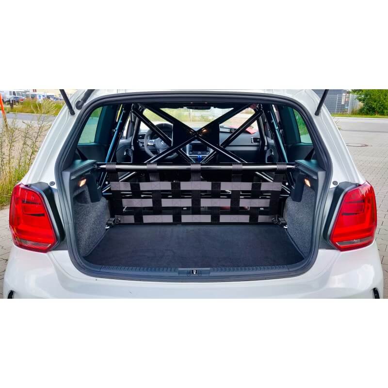 The open boot of a white VW Polo with a Stern strut bar and black and grey webbing net in front of a roll cage