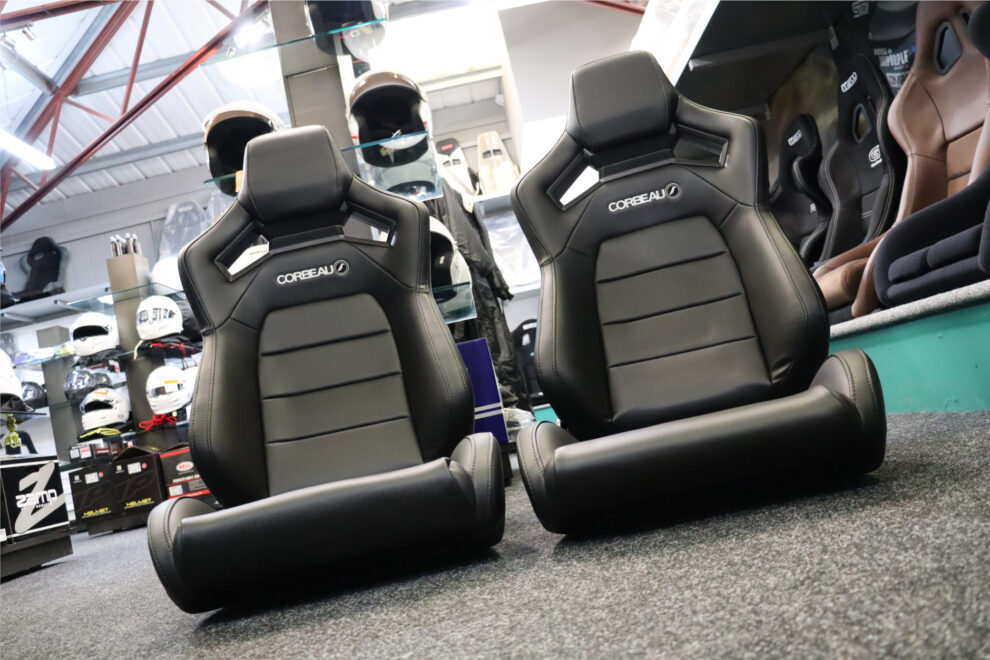 A pair of black vinyl Corbeau SVR reclining seats on the floor of the GSM Performance showroom