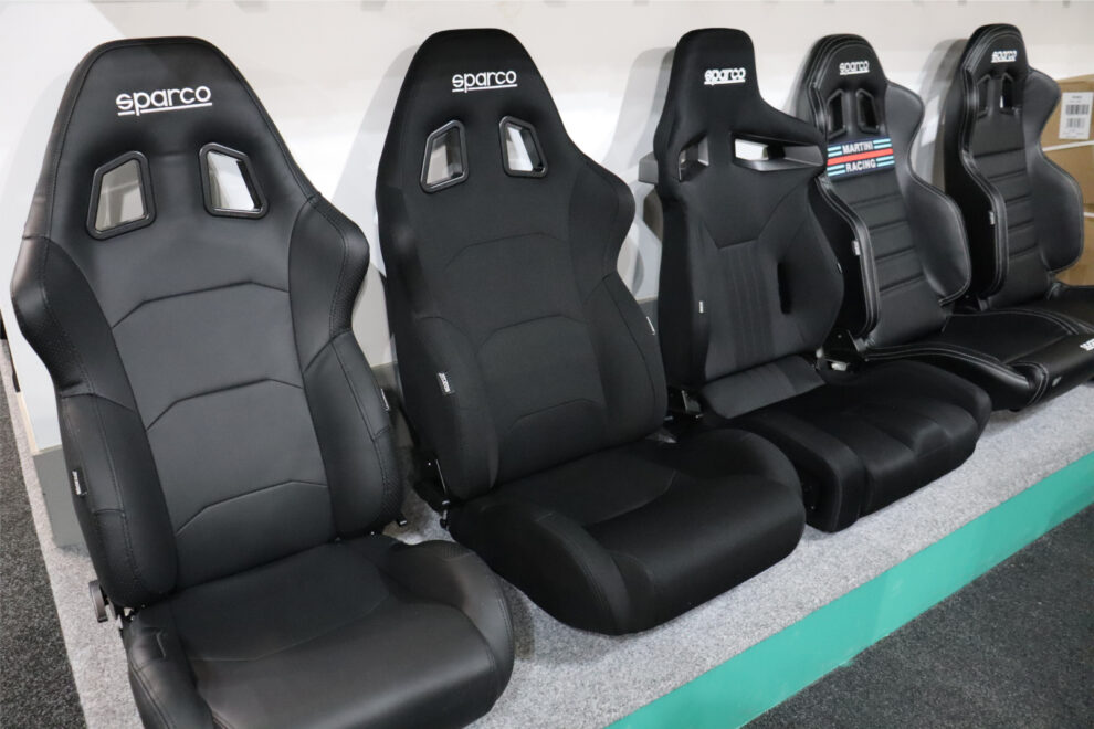 A row of black Sparco reclining sport seats on the display in the GSM Performance showroom, including an R100 Martini Racing