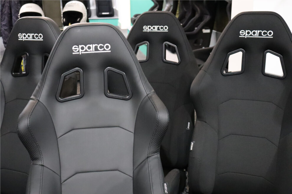 Close view of several black Sparco R500 reclining seats in vinyl and cloth on the showroom display