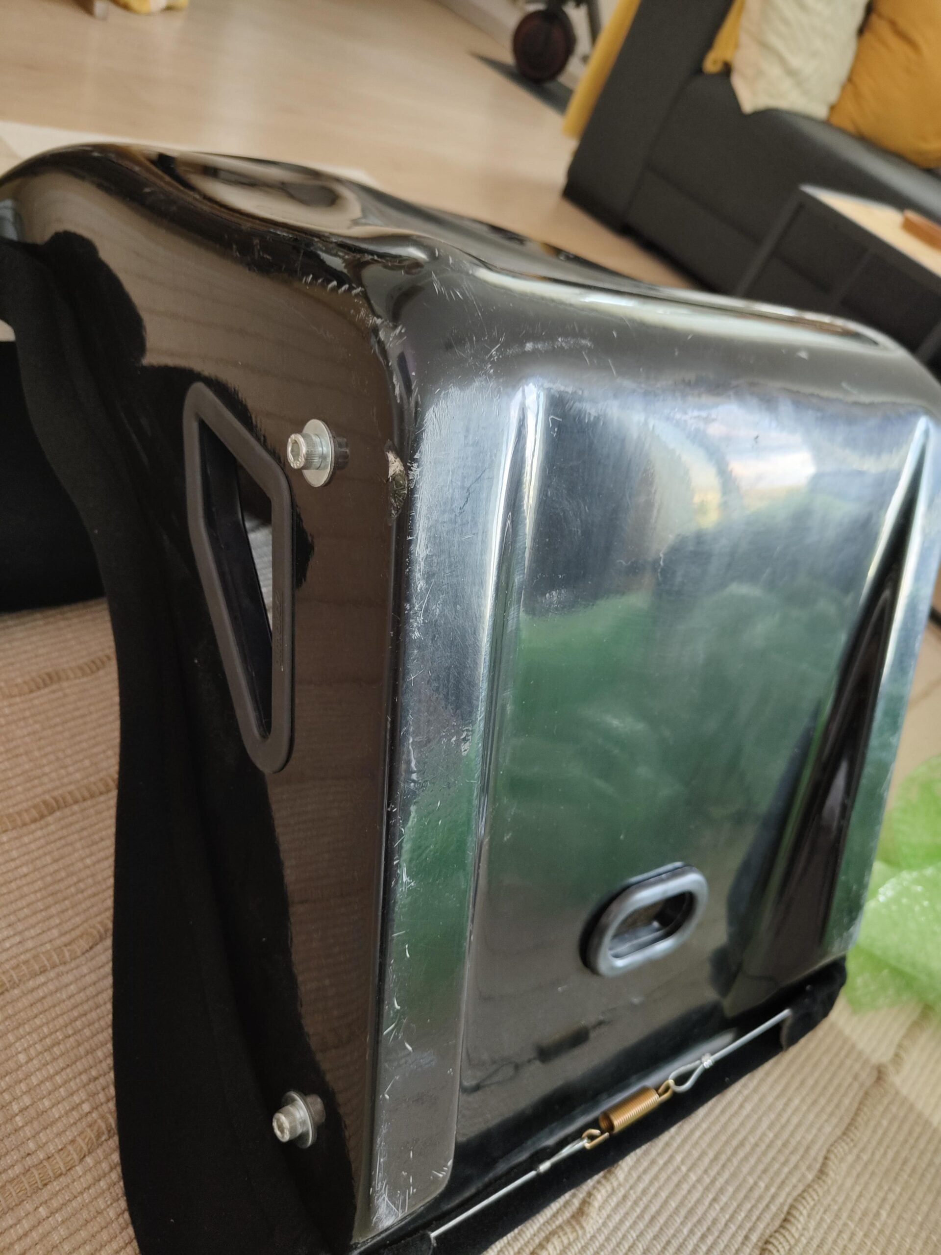 Scratches and scuffs along the gloss outer shell edge of a bucket seat