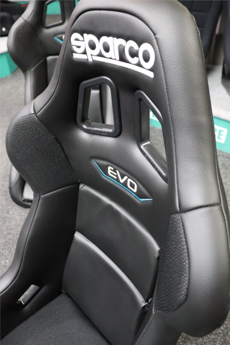 The black Sparco Evo shell with its harness slots and EVO badge in our showroom