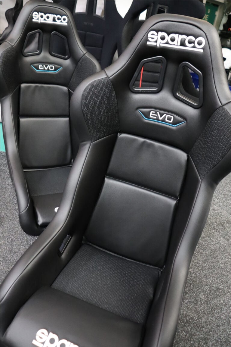 A black Sparco Evo bucket seat seen from the front and above in our showroom