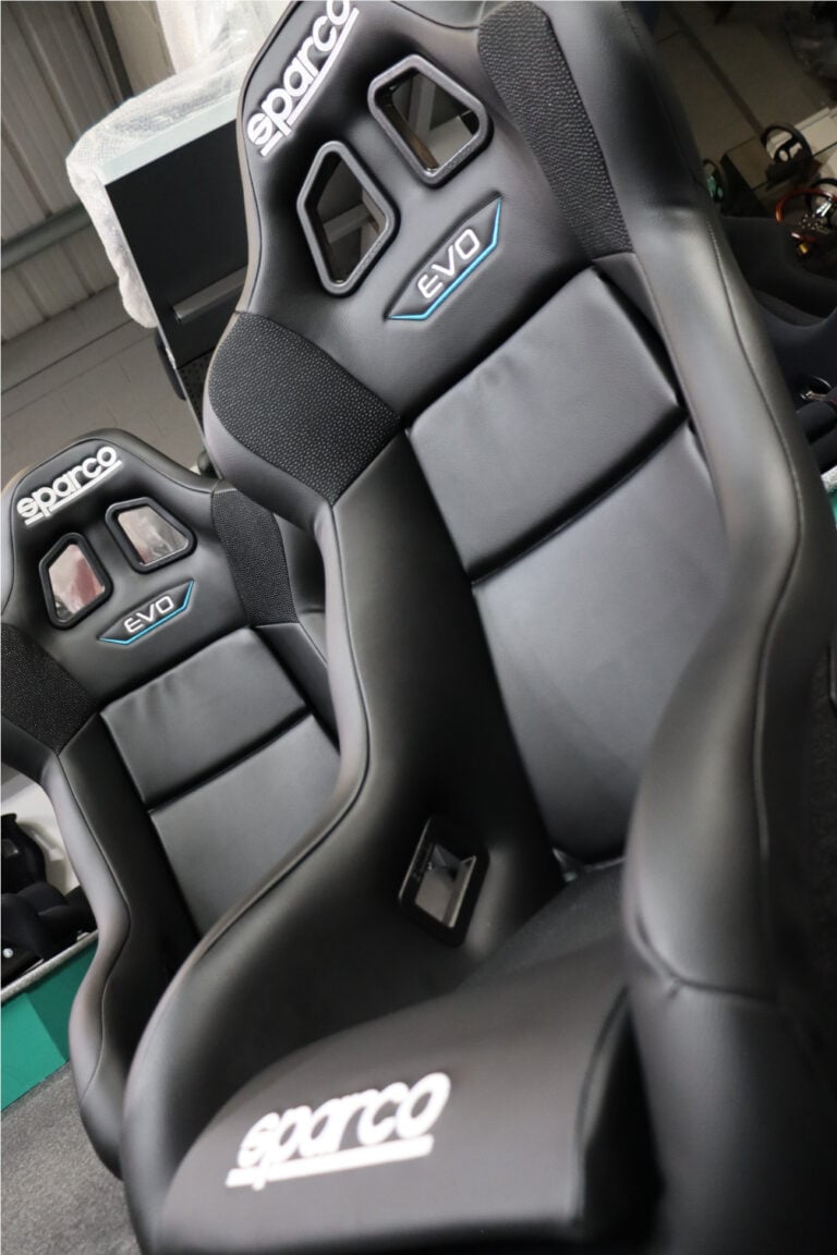Sparco Evo bucket seats lined up in our showroom with the Sparco logo on the seat base