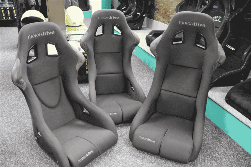 Three Motordrive Club Pro FIA bucket seats side by side on the SportSeats4u showroom floor