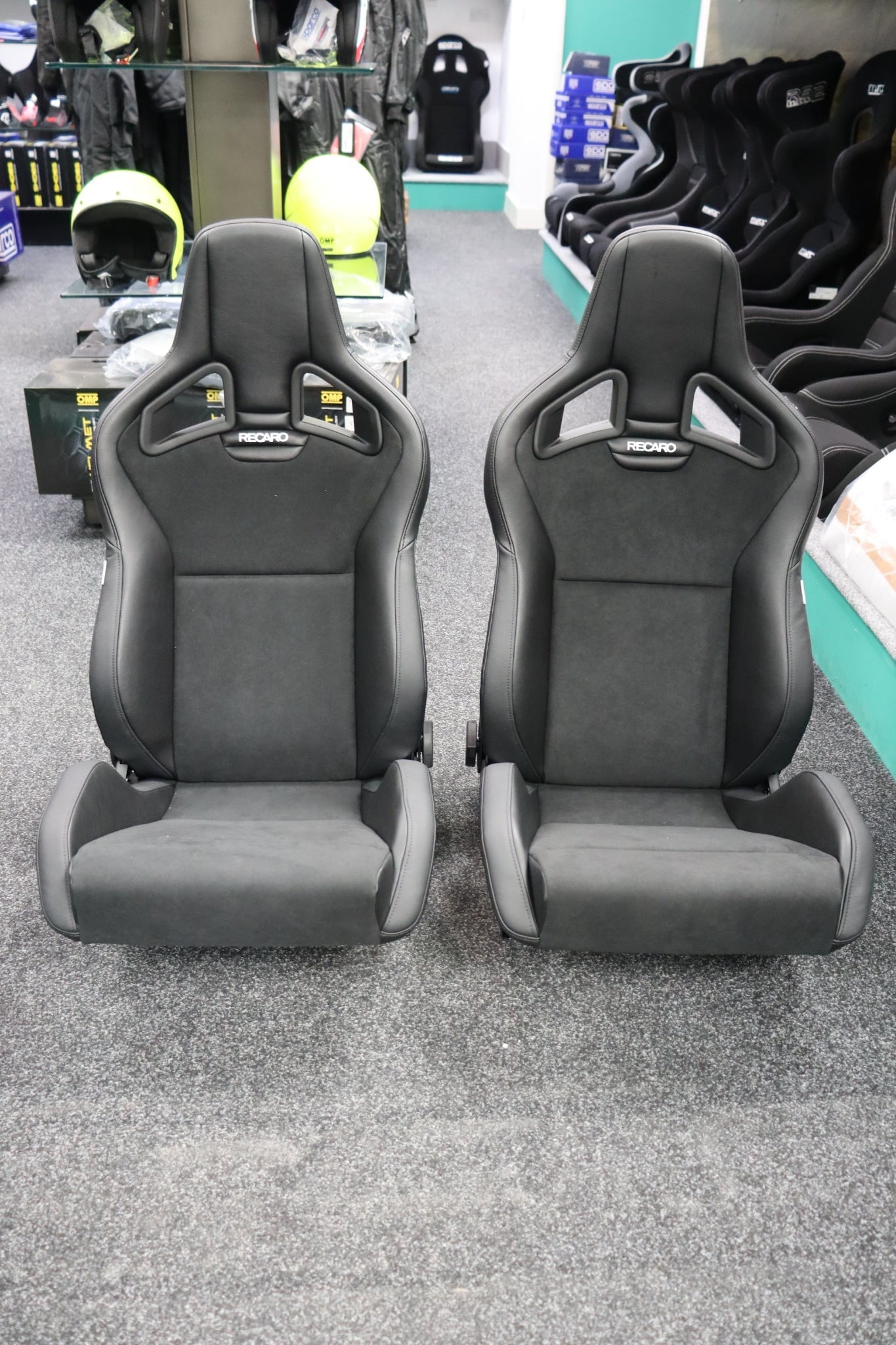 Pair of Recaro Sportster CS reclining sport seats in Ambla leather and Dinamica suede on the showroom floor