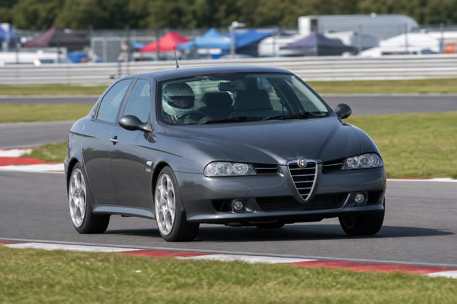 Alfa Romeo 156 on track with a helmeted driver