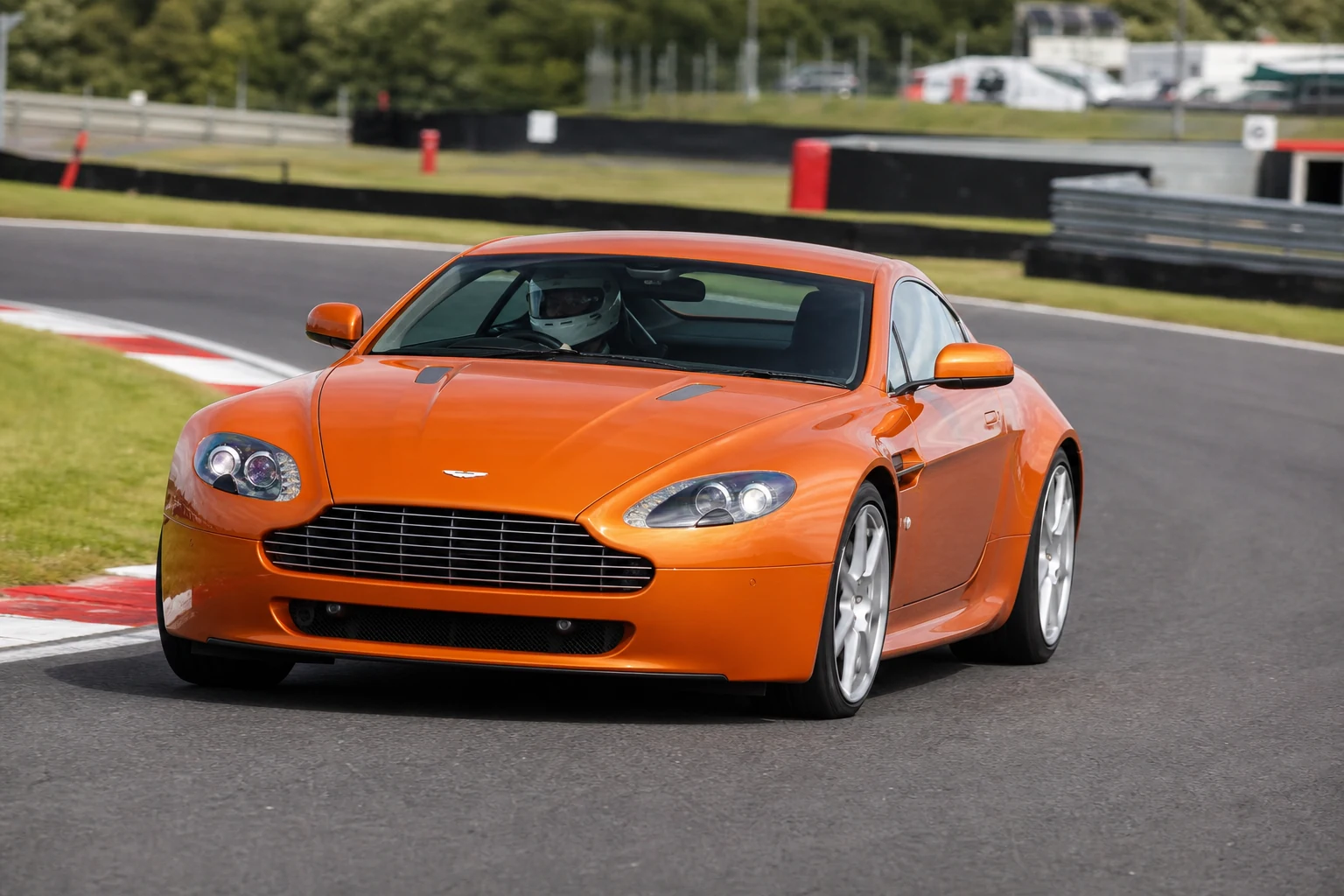 Aston Martin Vantage 05-18 on track with a helmeted driver