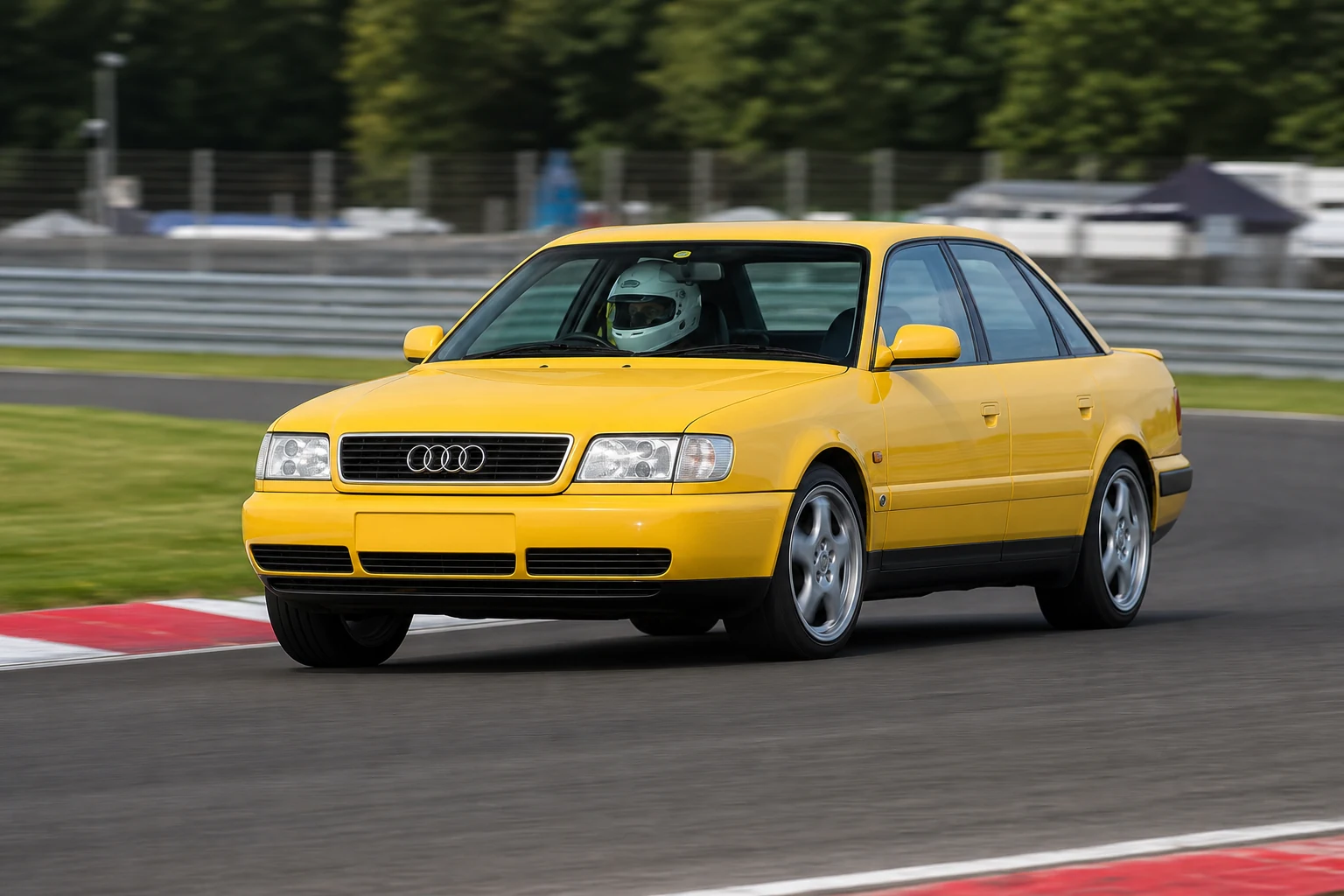 Audi A6 C4 on track with a helmeted driver