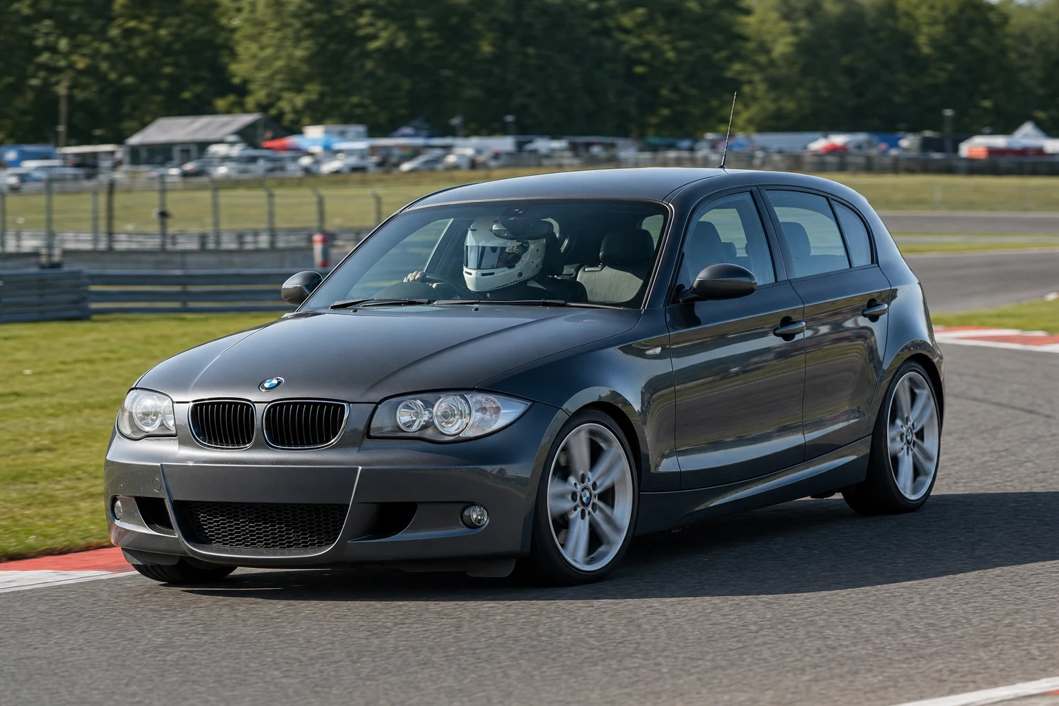 BMW 1 Series (E81/E82/E87/E88) on track with a helmeted driver