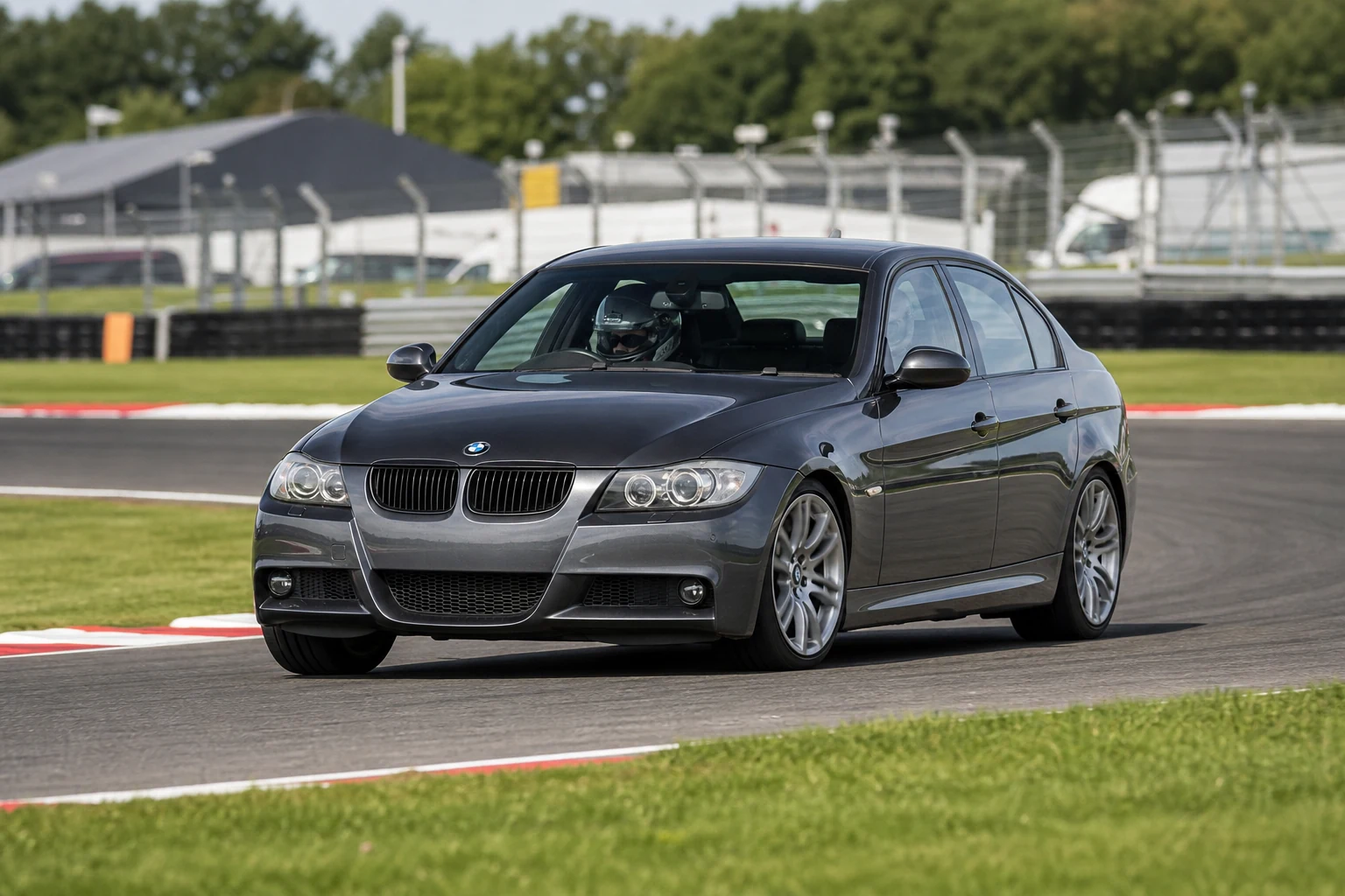 BMW 3 Series E90 on track with a helmeted driver