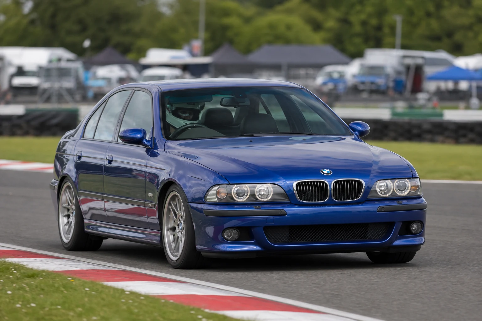 BMW 5 Series E39 on track with a helmeted driver