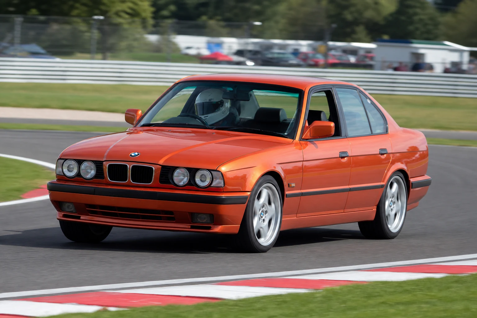 BMW E34 on track with a helmeted driver
