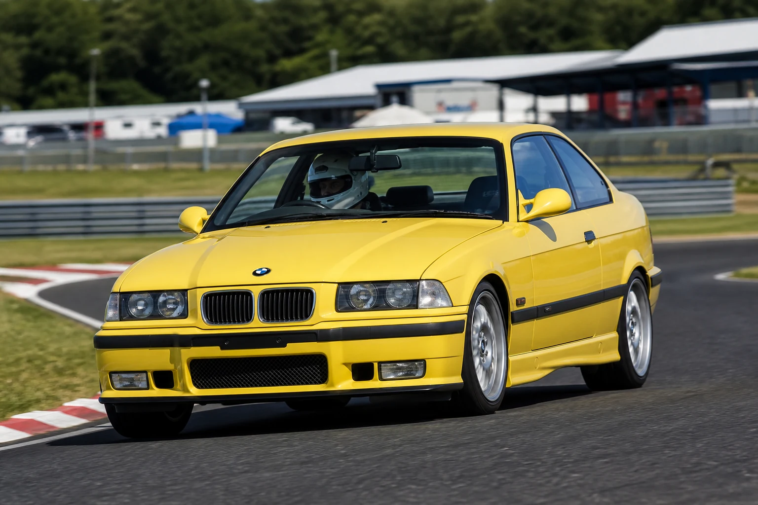 BMW E36 on track with a helmeted driver