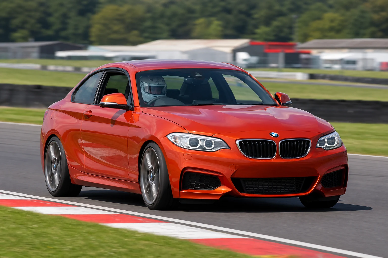 BMW F22 on track with a helmeted driver