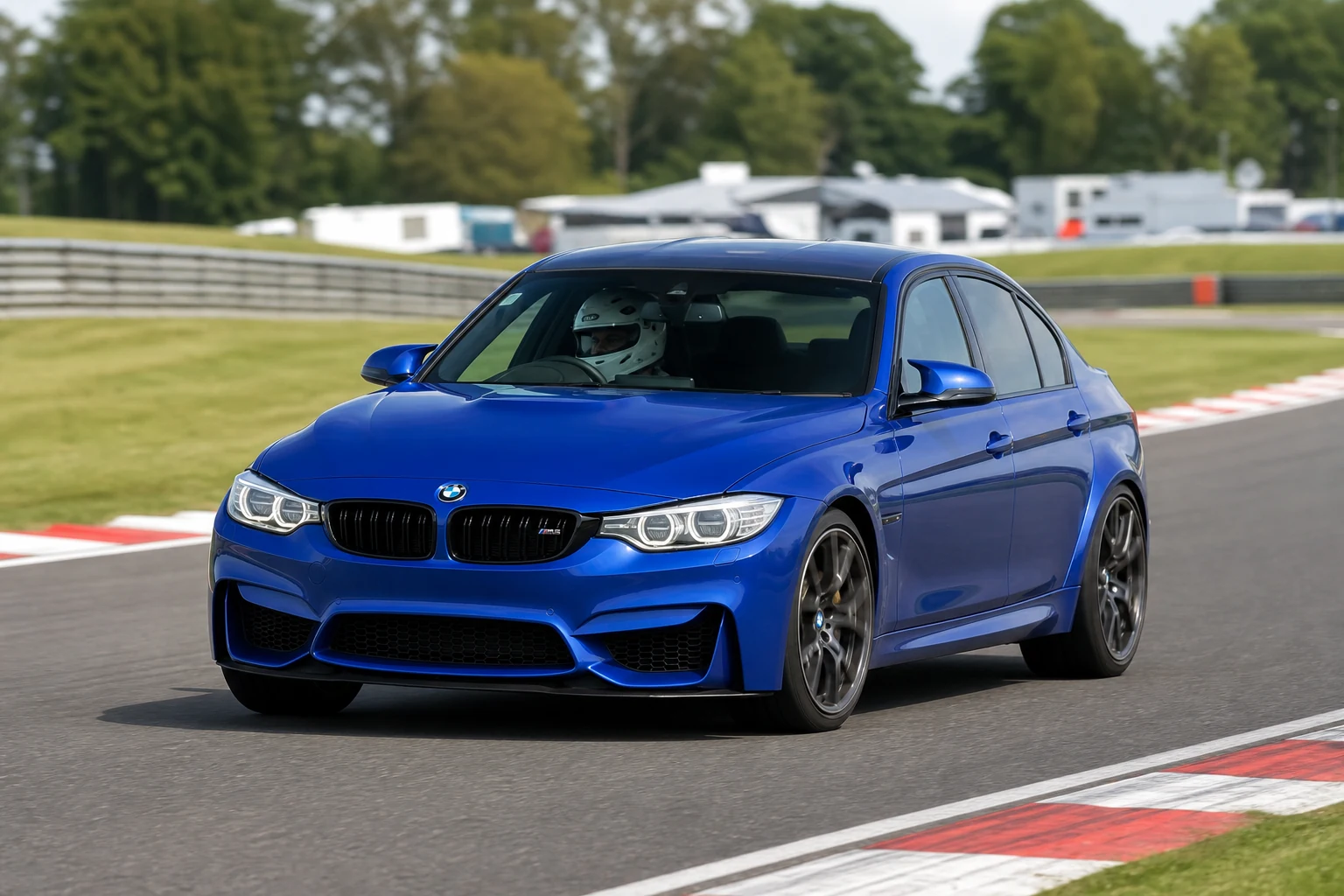 BMW F80 M3 on track with a helmeted driver