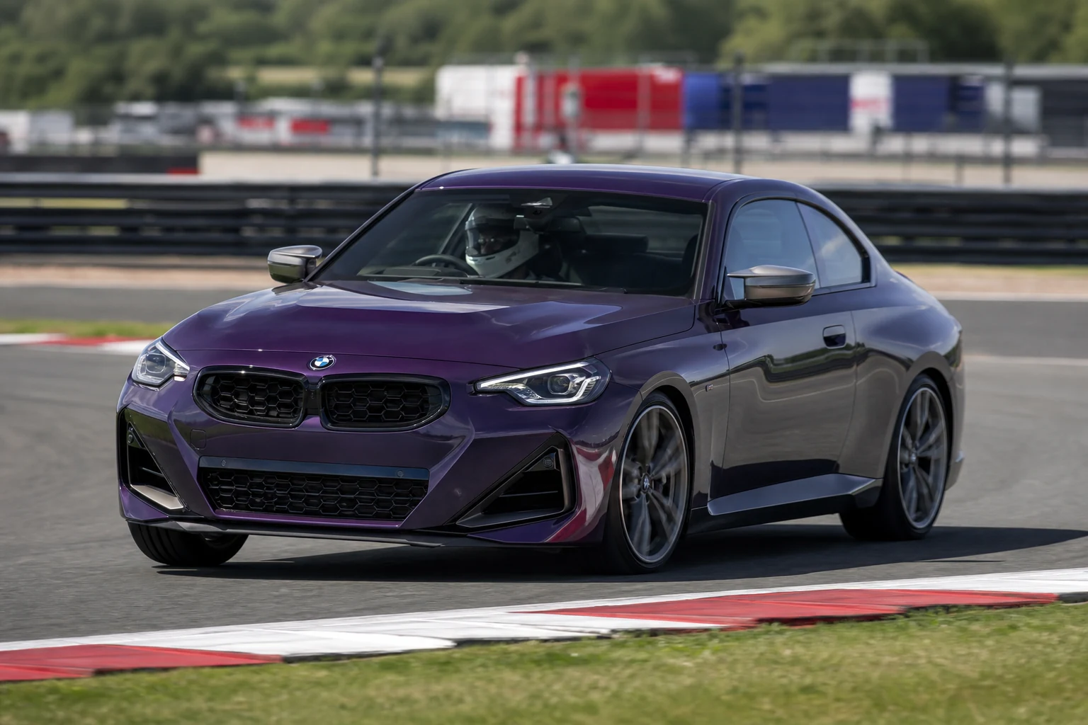 BMW M240i on track with a helmeted driver
