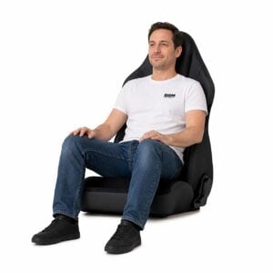 Person seated in Bride edirb 110 Reclining Sports Seat (part I10NSP) showing real-world seat size and fit – GSM Performance