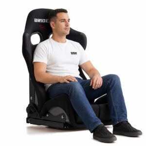 Person seated in Bride GIAS III Reclining Sports Seat (part G61ASF) showing real-world seat size and fit – GSM Performance