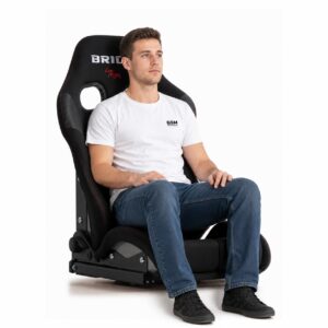 Person seated in Bride STRADIA III Reclining Sports Seat (part G71GS) showing real-world seat size and fit – GSM Performance