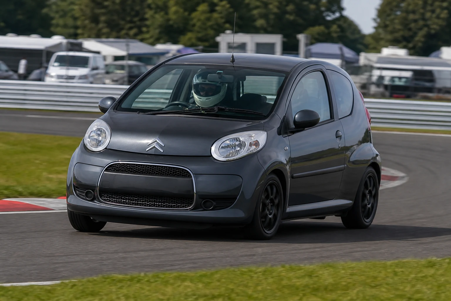 Citroen C1 on track with a helmeted driver