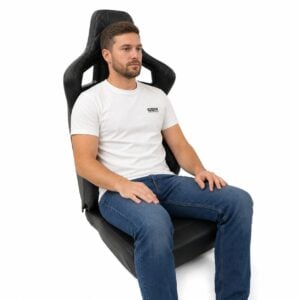 Person seated in Corbeau Sportline RRS Limited Edition Low Base Reclining Sport Seat showing real-world seat size and fit – GSM Performance