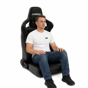 Person seated in Corbeau Sportline RRS Low Base Reclining Sport Seat (part RSRB) showing real-world seat size and fit – GSM Performance