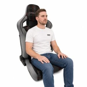 Person seated in Corbeau Sportline RRS Tartan Edition Reclining Sport Seat (part RRS-TartanEdV) showing real-world seat size and fit – GSM Performance