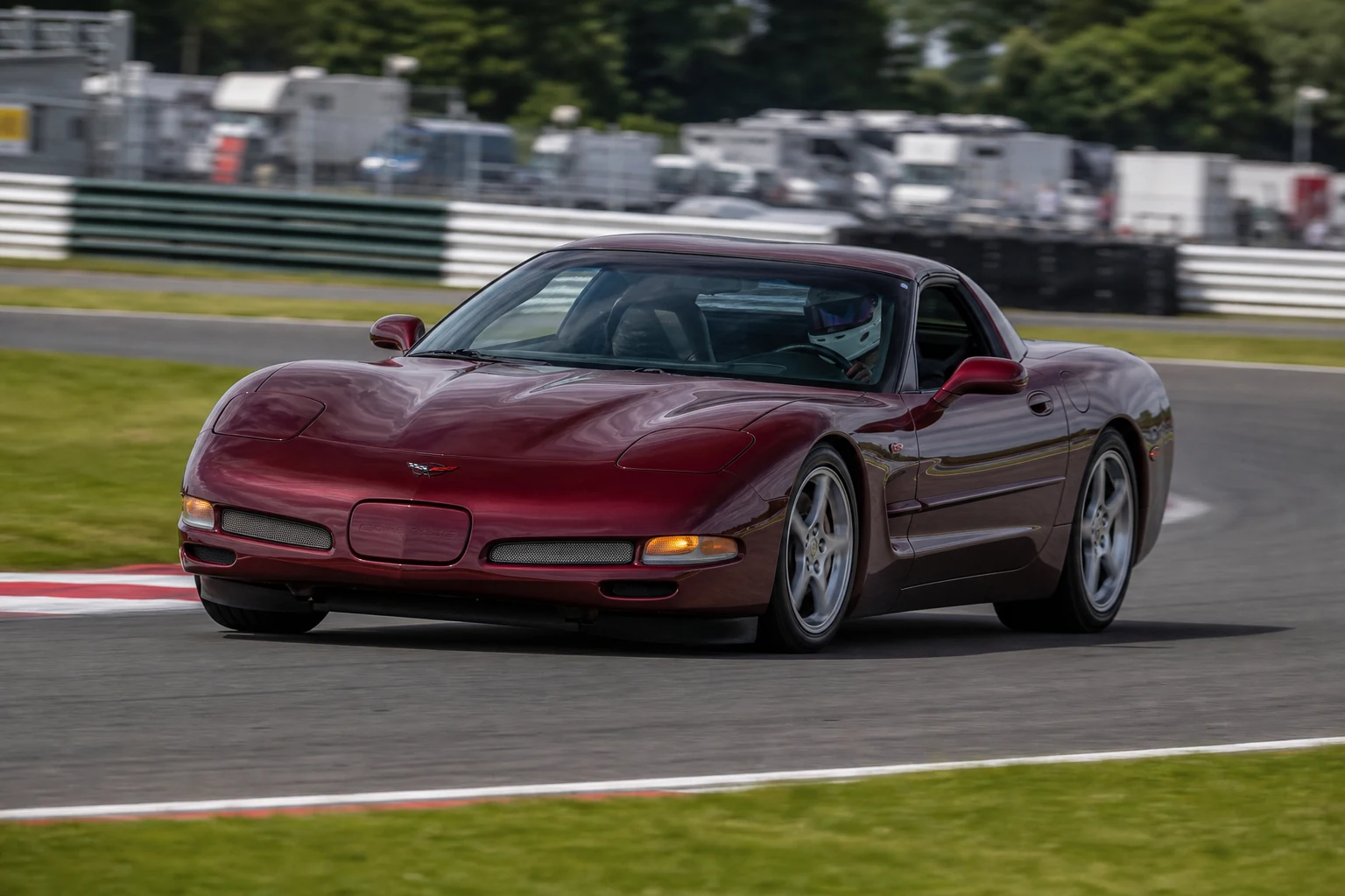Corvette C5 on track with a helmeted driver