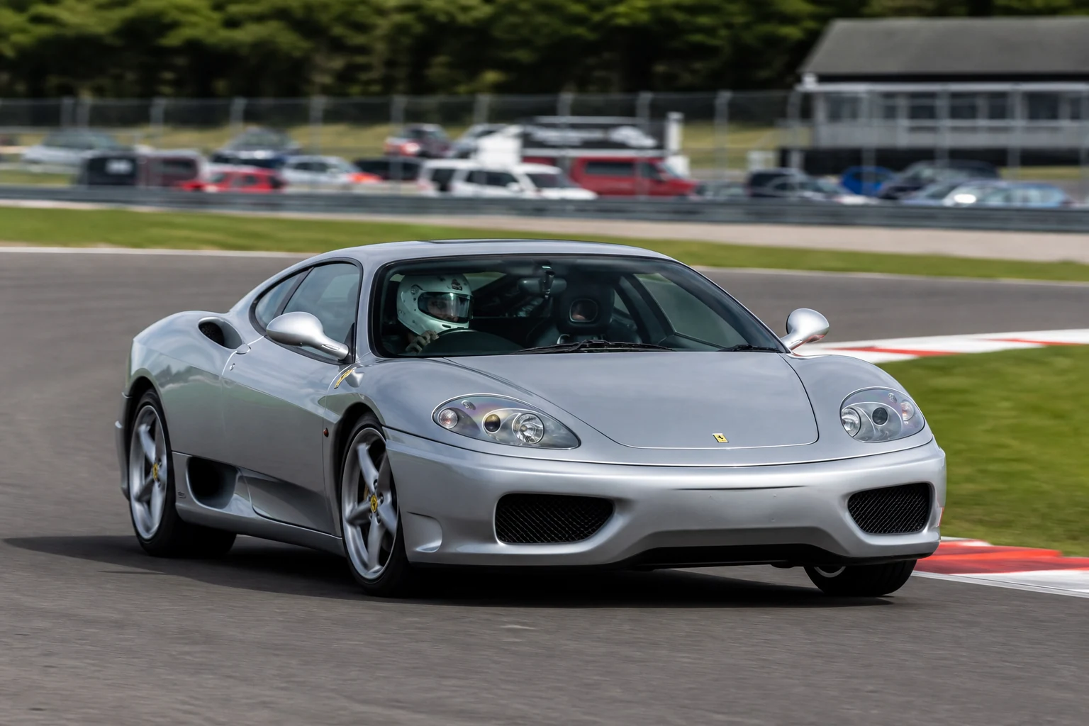 Ferrari 360 on track with a helmeted driver