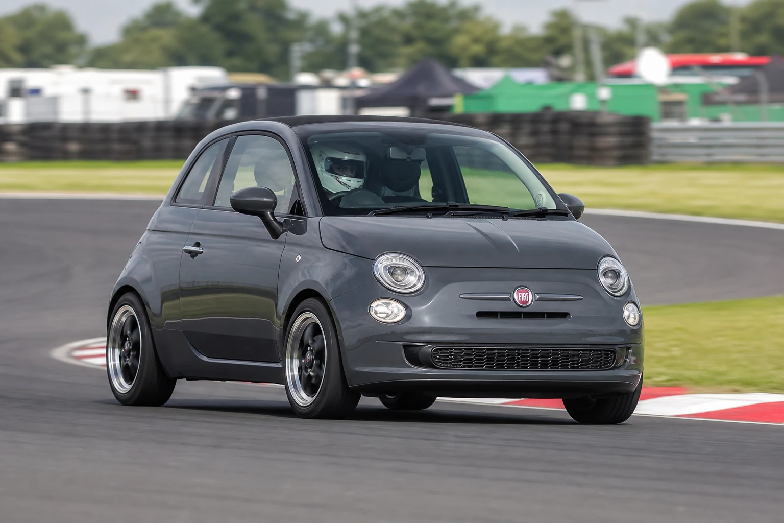 Fiat 500 on track with a helmeted driver