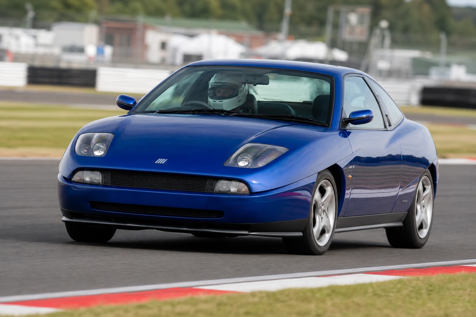 Fiat Coupe on track with a helmeted driver