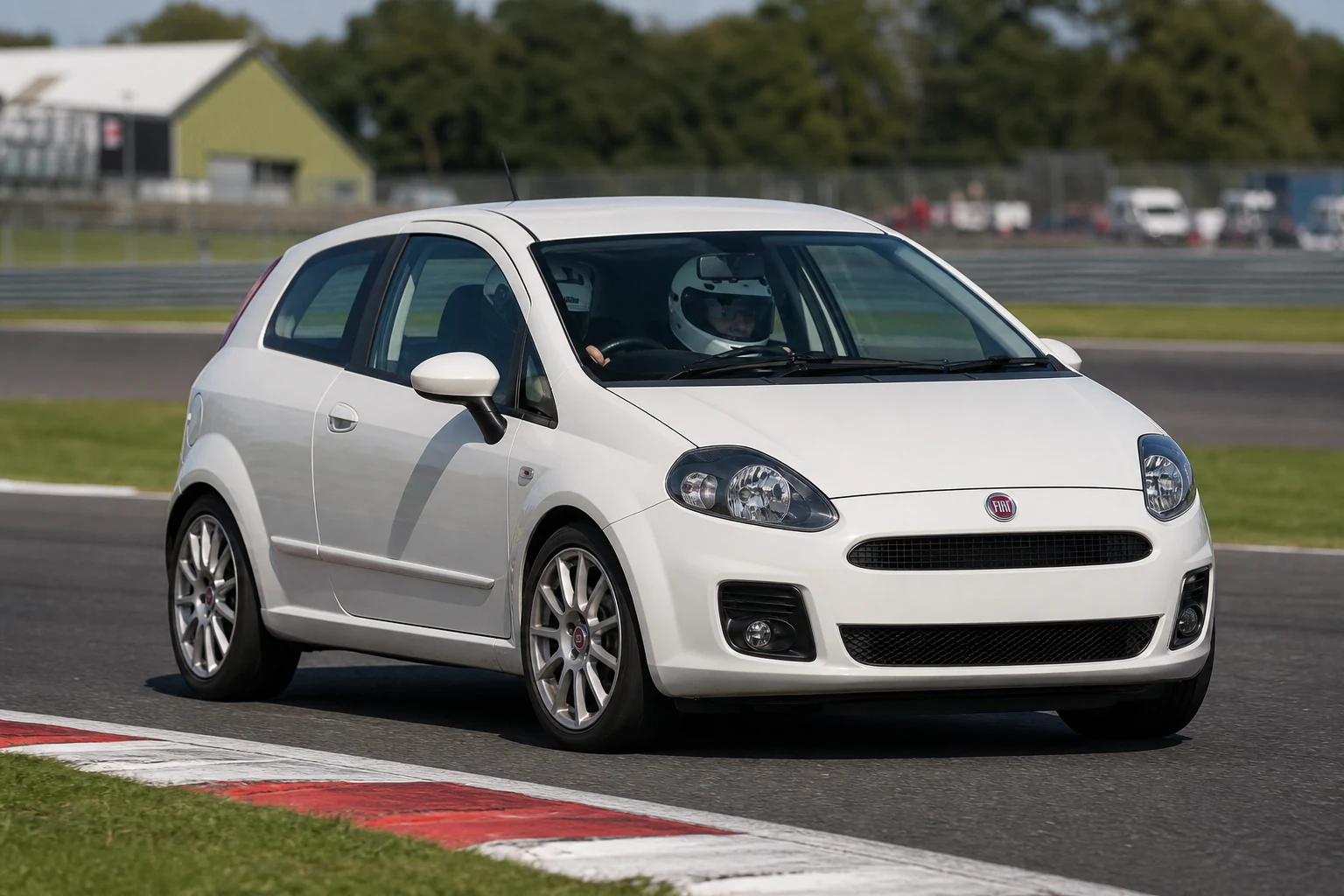 Fiat Grande Punto on track with a helmeted driver