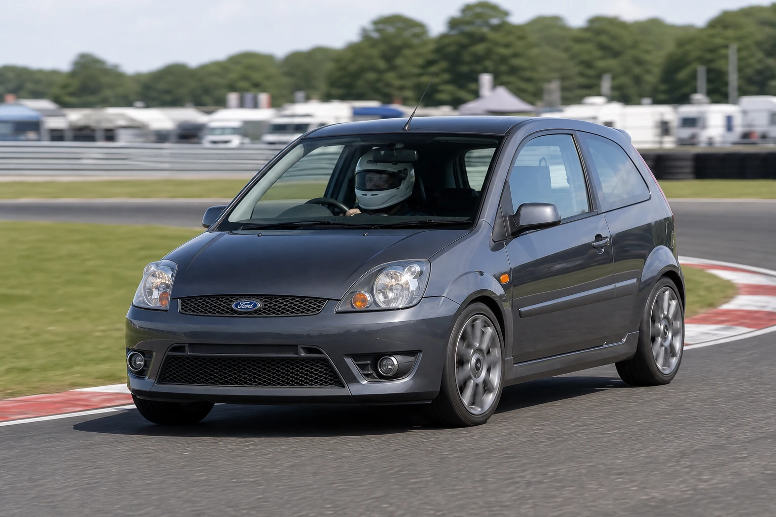 Ford Fiesta Mk5 on track with a helmeted driver