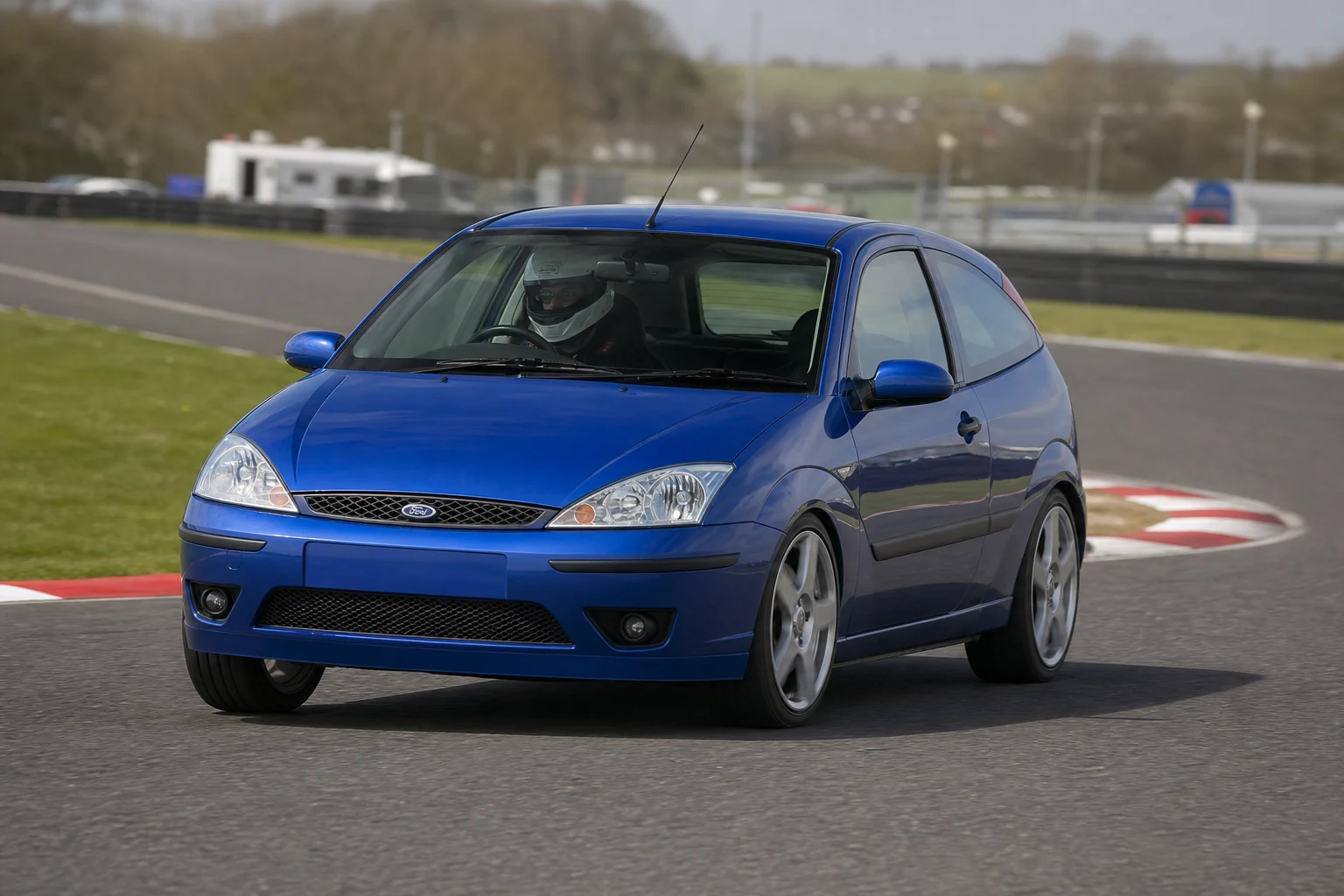 Ford Focus Mk1 on track with a helmeted driver