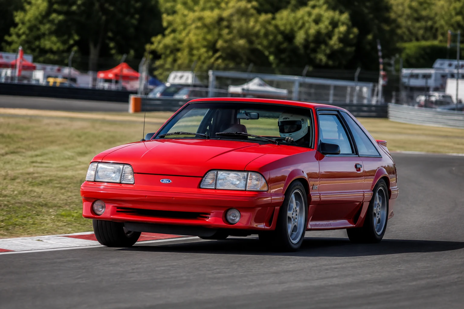 Ford Mustang Third Gen on track with a helmeted driver
