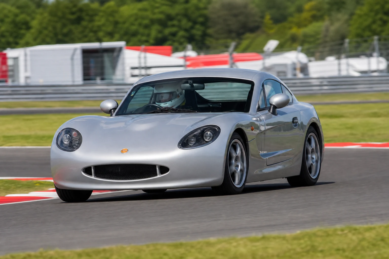 Ginetta G40 on track with a helmeted driver
