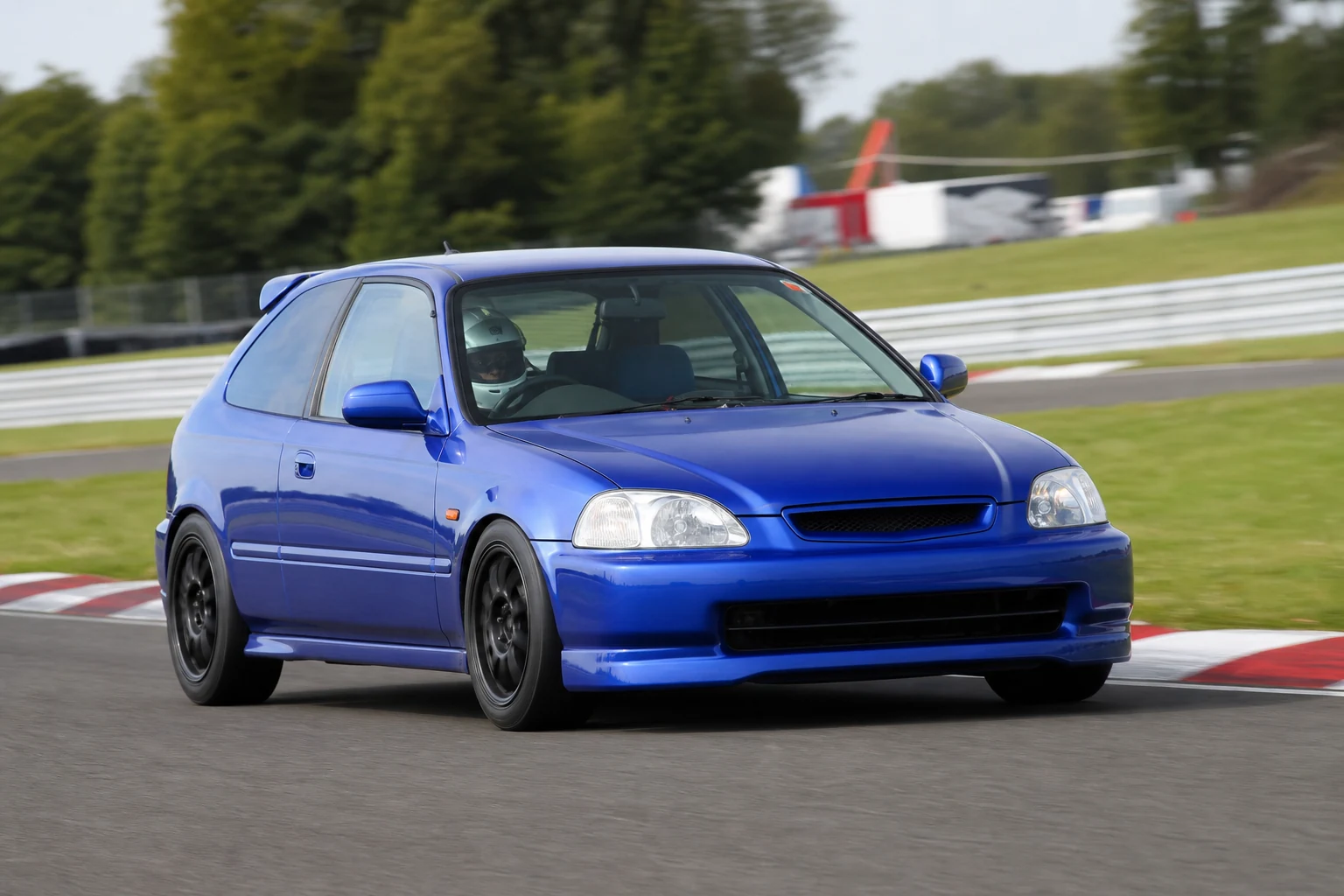 Honda Civic EK on track with a helmeted driver
