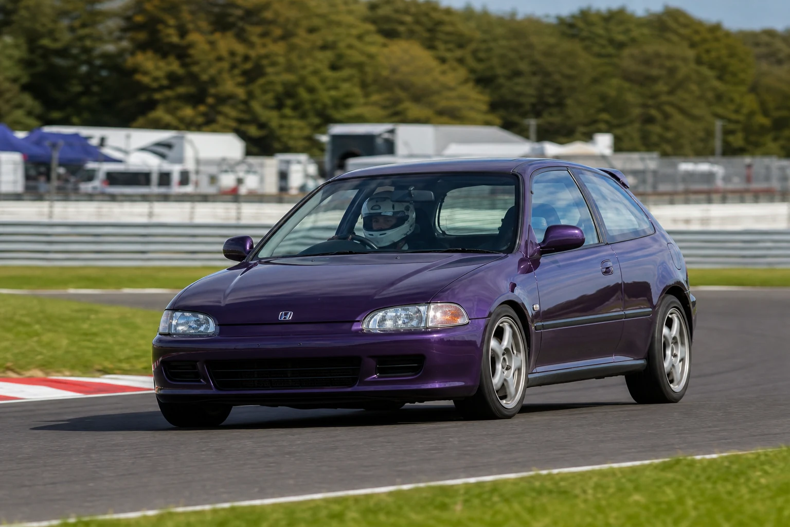 Honda Civic FK on track with a helmeted driver
