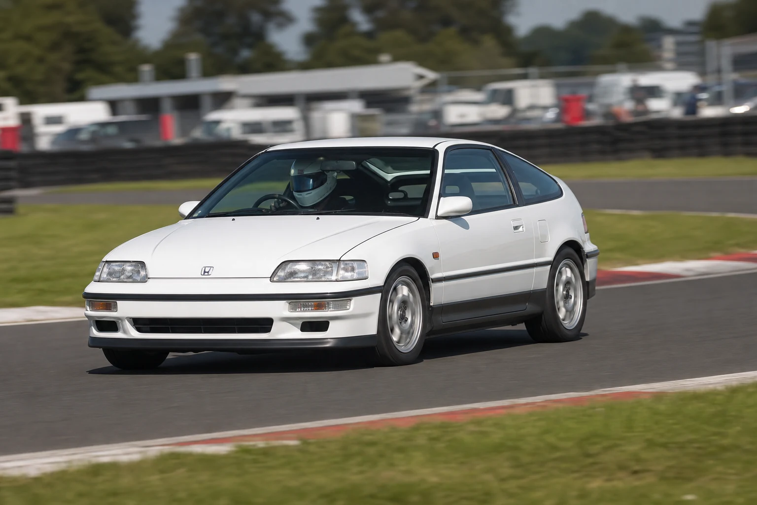 Honda CRX on track with a helmeted driver