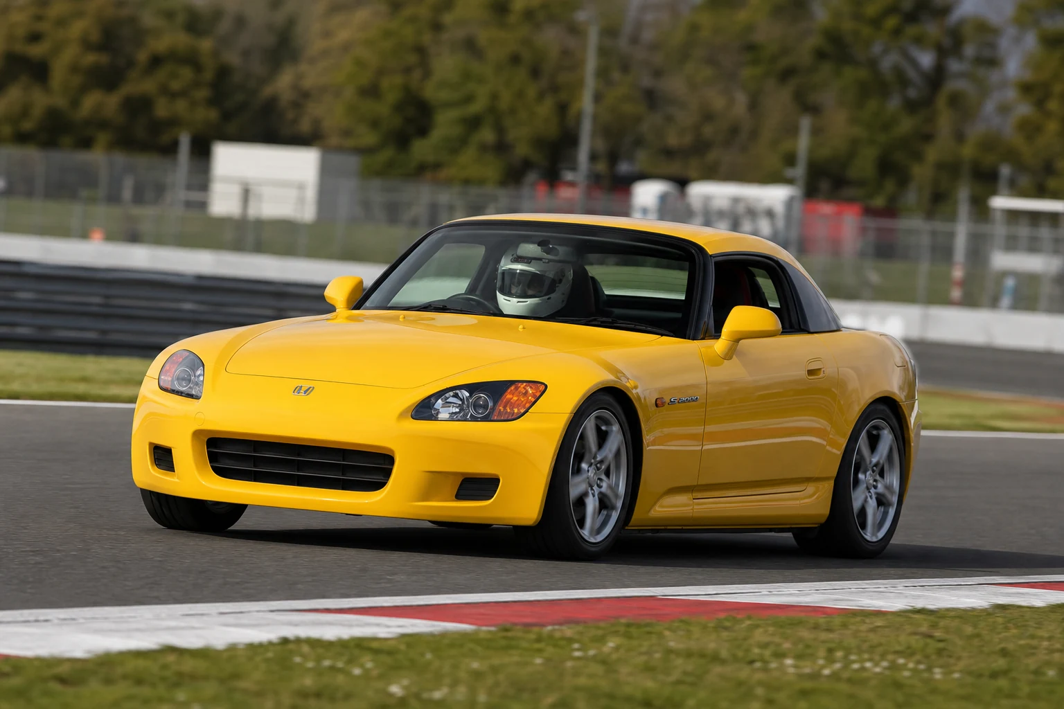 Honda S2000 on track with a helmeted driver