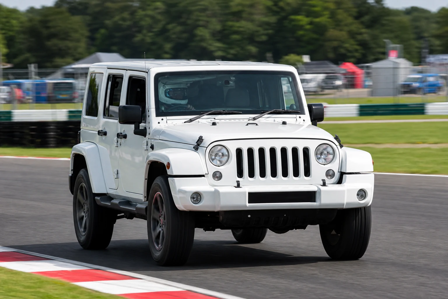 Jeep Wrangler JK 4 on track with a helmeted driver