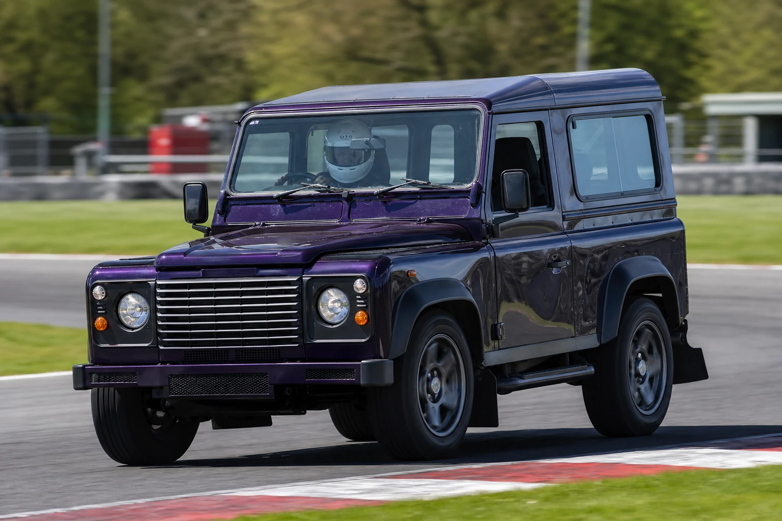 Land Rover Defender on track with a helmeted driver