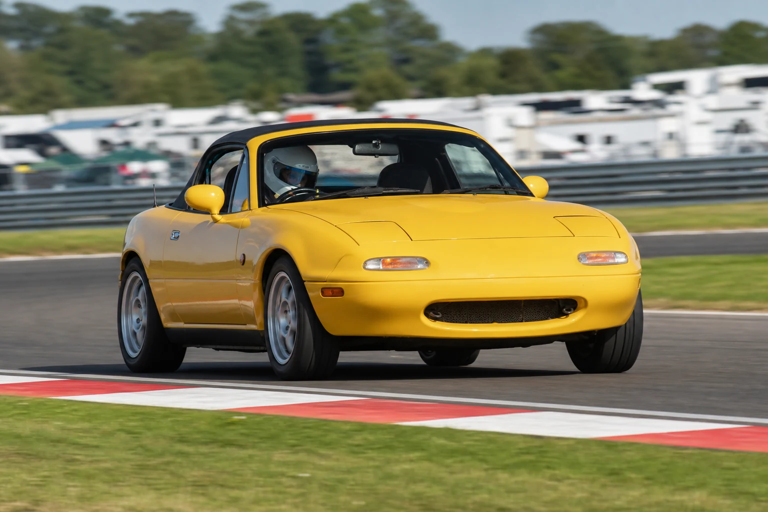 Mazda MX-5 Mk1/Mk2 on track with a helmeted driver