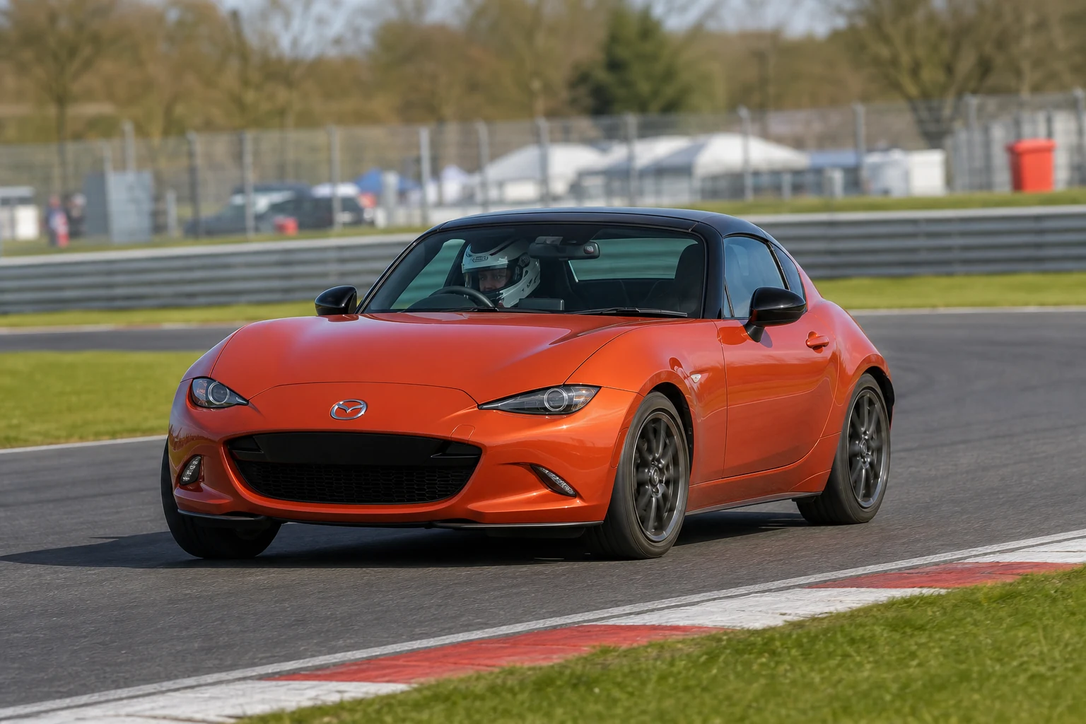 Mazda MX5 MK4 on track with a helmeted driver